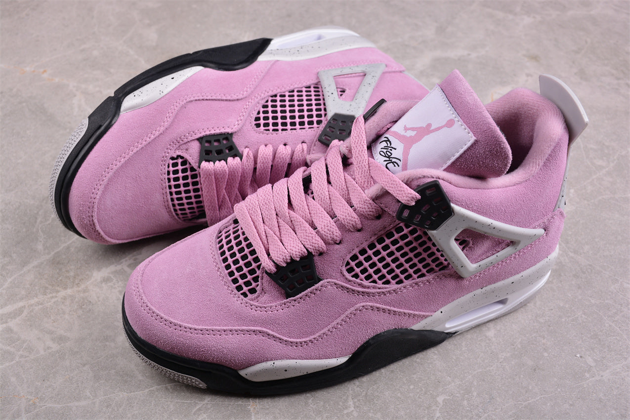 Pair of pink sneakers with black accents on a gray surface