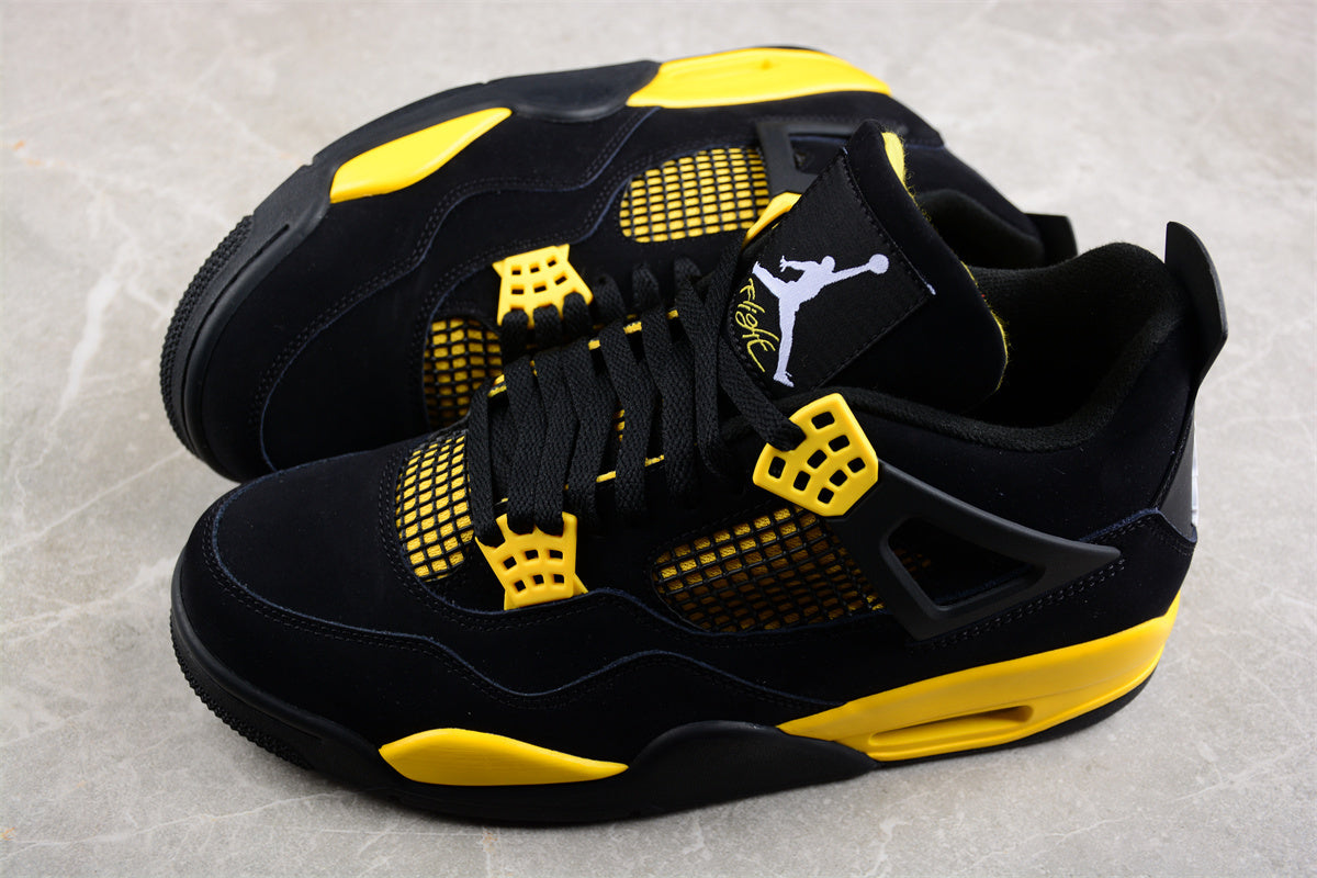 Black and yellow sneakers with a prominent brand logo on a light gray background